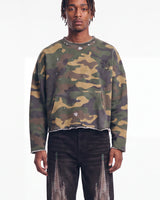 Saint Vanity Camo Crewneck in woodland camo, upper body front view on model showing the raw cut hem and paint splatter