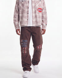 Bravest Studios Liberty Flare Denim brown, waist-down front view on model showing the flared leg and flag rips