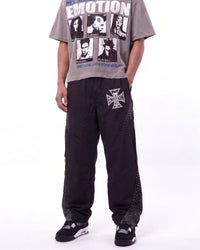 Mixed Emotions Classic Nylon Pant black, waist-down front view on model showing the rhinestone Iron Cross logo