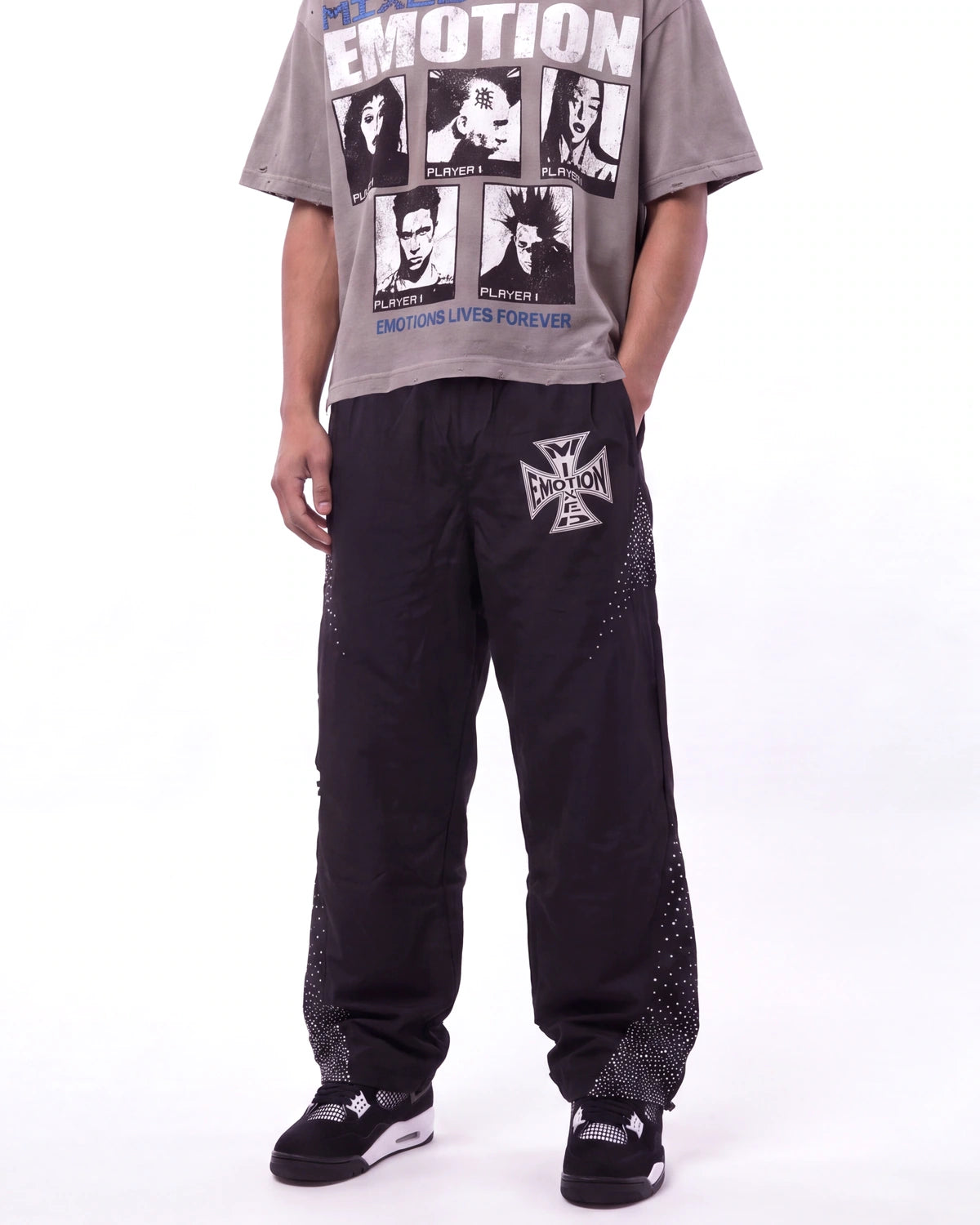 Mixed Emotions Classic Nylon Pant black, waist-down front view on model showing the rhinestone Iron Cross logo