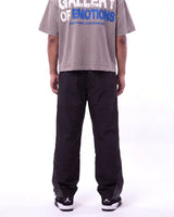 Mixed Emotions Classic Nylon Pant black, waist-down rear view on model showing the black nylon leg