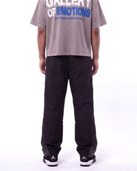 Mixed Emotions Classic Nylon Pant black, waist-down rear view on model showing the black nylon leg