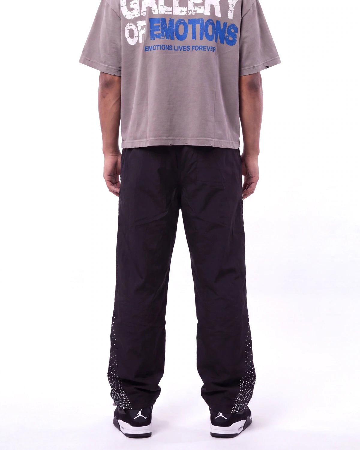 Mixed Emotions Classic Nylon Pant black, waist-down rear view on model showing the black nylon leg