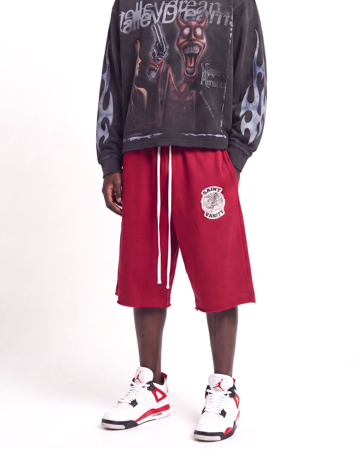 Saint Vanity Crimson Uniform Shorts red, waist-down front view on model showing the crest logo and drawcord