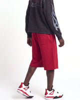 Saint Vanity Crimson Uniform Shorts red, waist-down side view on model showing the crimson fleece