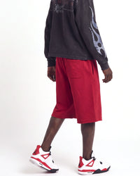 Saint Vanity Crimson Uniform Shorts red, waist-down side view on model showing the crimson fleece