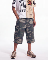 Bravest Studios Half Puzzle Tee tan, worn on model with camo cargo shorts, lower front view