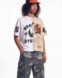 Bravest Studios Half Puzzle Tee tan, upper body front view on model showing the split varsity and animal panels