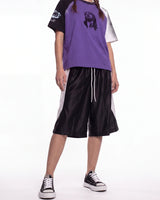 Bravest Studios Baggy Basketball Shorts black, front view on model showing the white side panels and drawcord