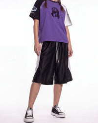 Bravest Studios Baggy Basketball Shorts black, front view on model showing the white side panels and drawcord