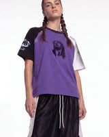 Bravest Studios Sacrament Tee purple, upper body front view on model showing the portrait graphic and raglan sleeves