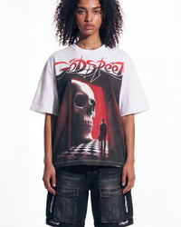 A model wearing a white Godspeed t-shirt with a large red, black, and white graphic print of a skull and a figure in a corridor, paired with dark cargo shorts.