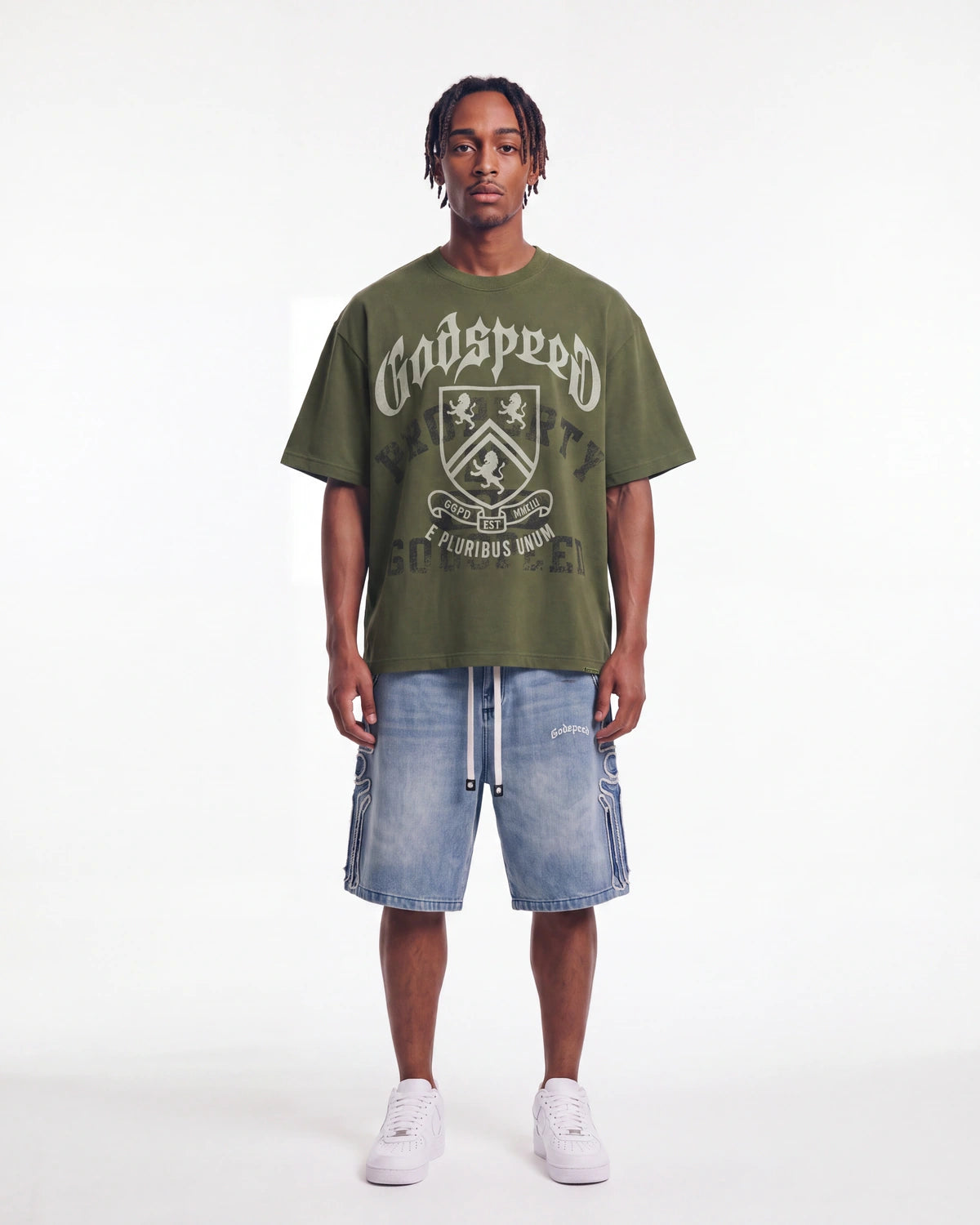 Godspeed Collegiate Tee Olive Wash, worn by a model with light wash denim shorts, full front view