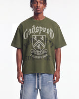 Godspeed Collegiate Tee Olive Wash, cropped on-model front view showing the crest graphic and boxy fit
