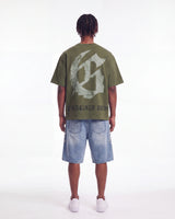 Godspeed Collegiate Tee Olive Wash, worn by a model showing the gothic G monogram back print, full back view