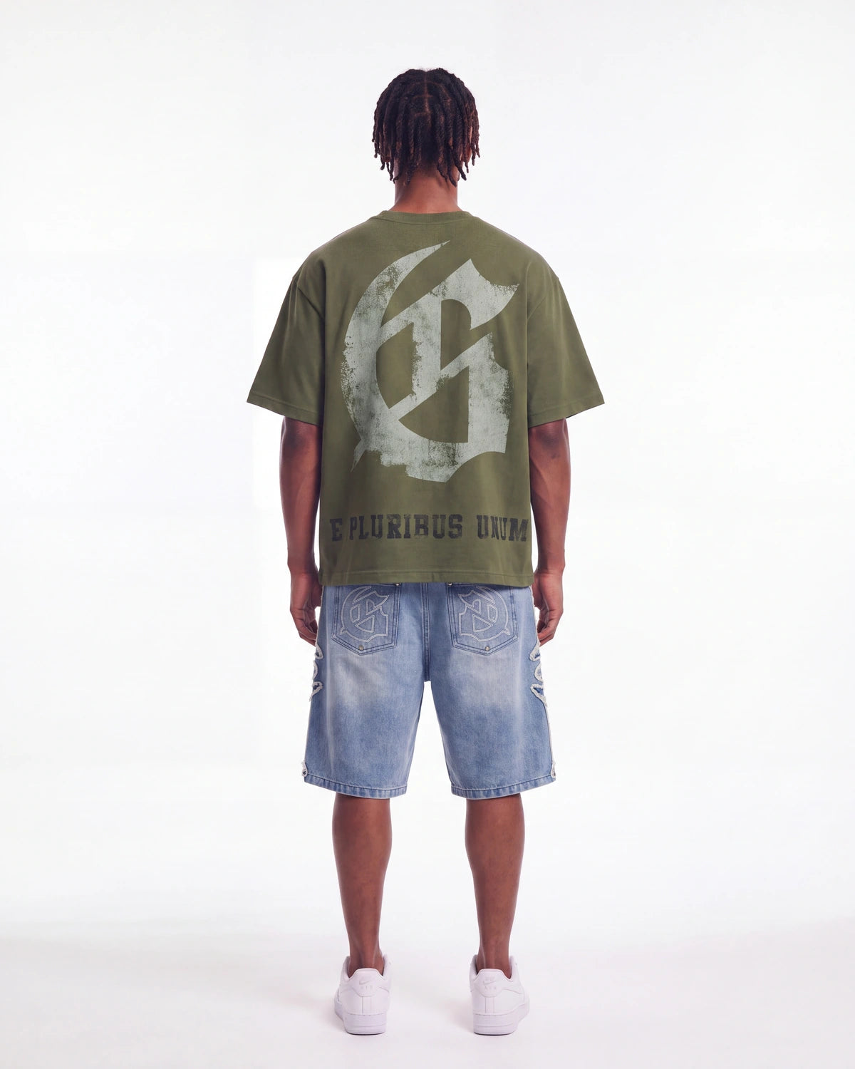 Godspeed Collegiate Tee Olive Wash, worn by a model showing the gothic G monogram back print, full back view