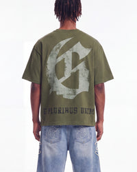 Godspeed Collegiate Tee Olive Wash, cropped on-model back view showing the gothic G monogram