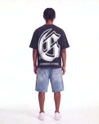 Godspeed Silencio Tee Black Wash, worn by a model, full-length back view showing the G monogram print