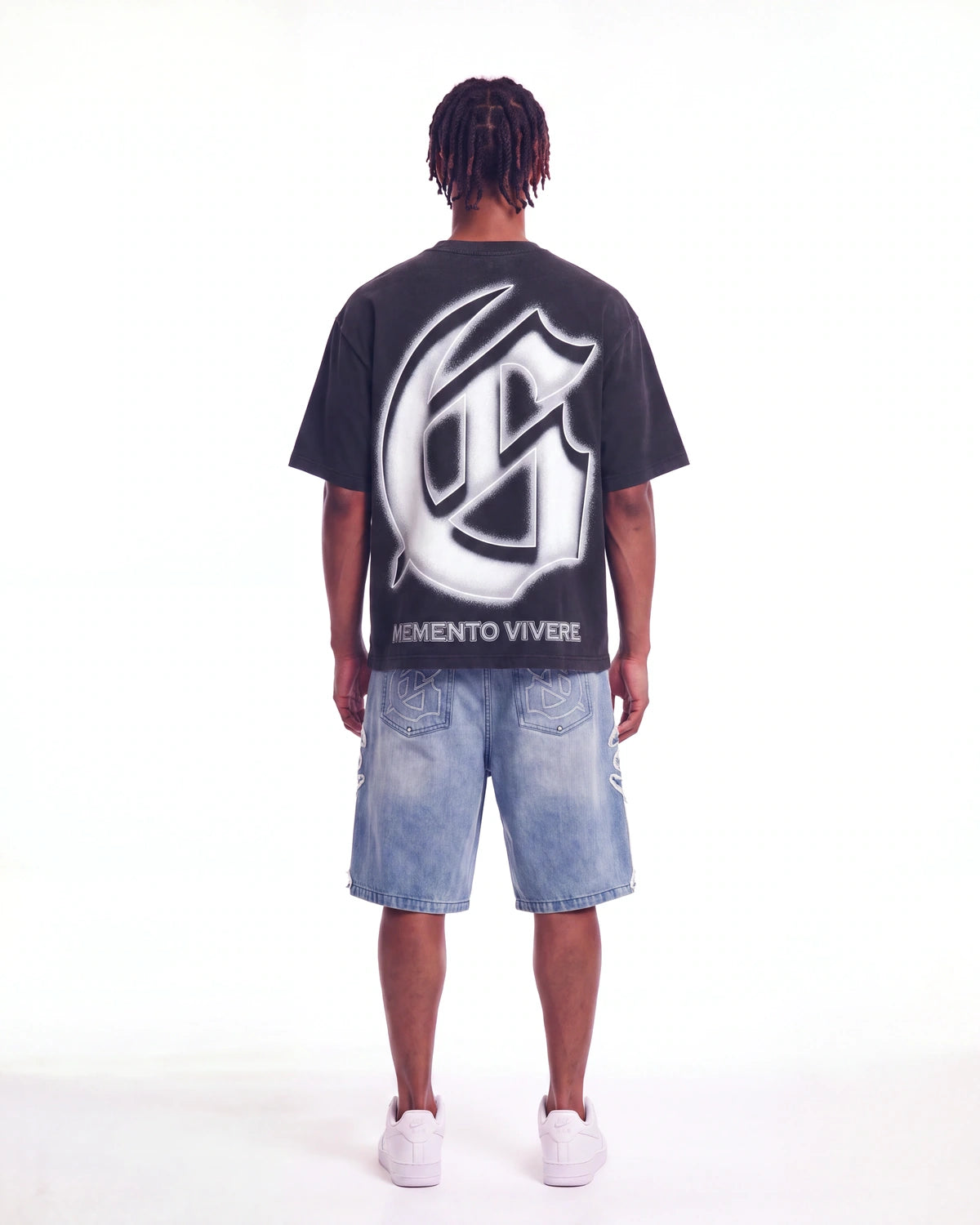 Godspeed Silencio Tee Black Wash, worn by a model, full-length back view showing the G monogram print
