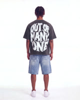 Godspeed 8Ball CP Tee Black Wash, worn by a model, full-length back view showing the OUT OF MANY, ONE print