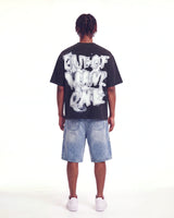 Godspeed No Risk No Reward Tee Black Wash, worn by a model, full-length back view showing the bubble lettering