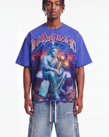 Godspeed Finally Tee blue, upper body front view on model showing the Statue of Liberty and gold trophy graphic