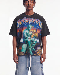 Godspeed Finally Tee black, upper body front view on model showing the Statue of Liberty and gold trophy graphic
