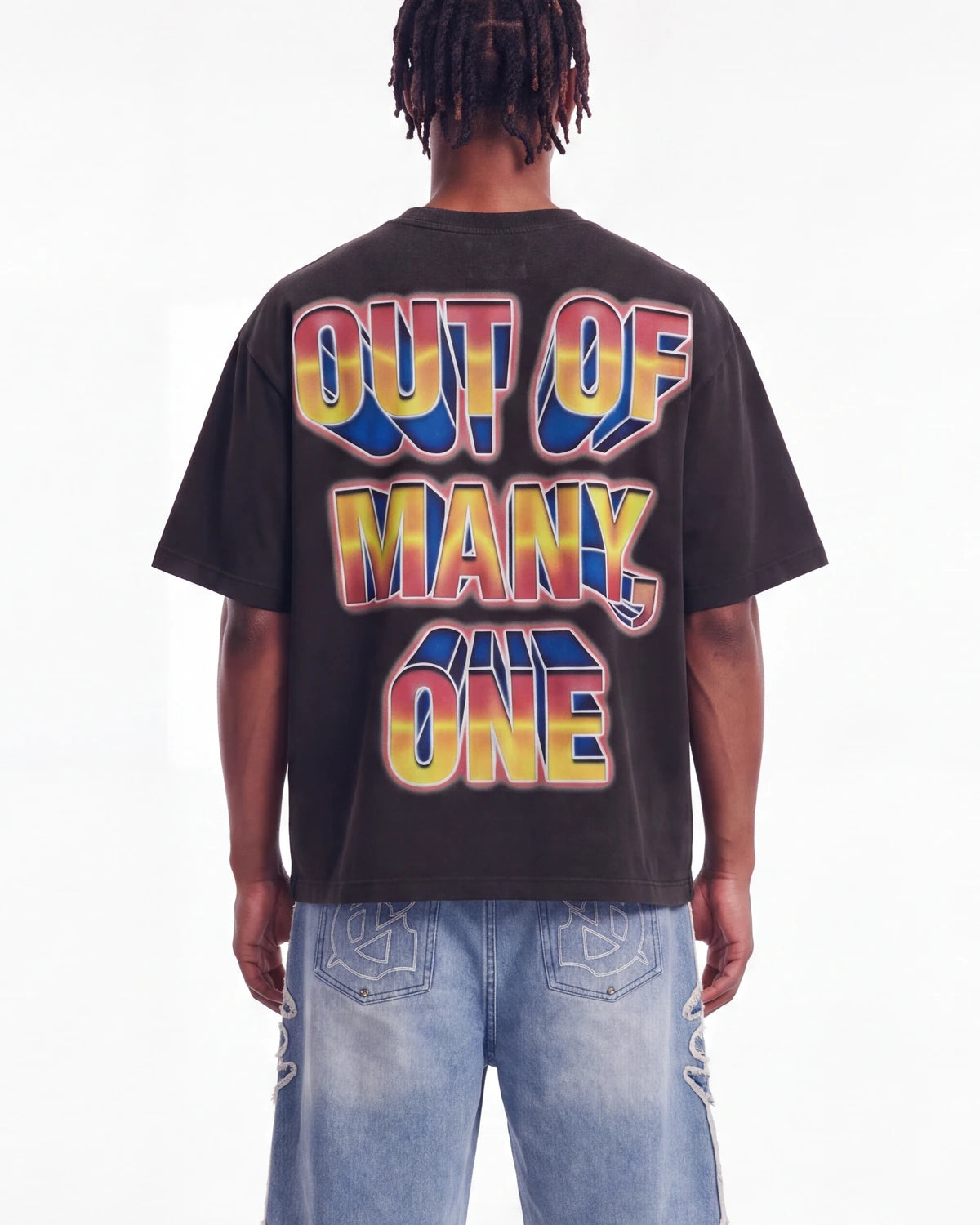 Godspeed Finally Tee black, upper body rear view on model showing the OUT OF MANY, ONE block lettering