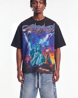 Godspeed Liberty Reigns Tee black, upper body front view on model showing the Statue of Liberty lightning storm graphic