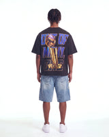Godspeed Liberty Reigns Tee black, full rear view on model showing the gold trophy and OUT OF MANY, ONE lettering