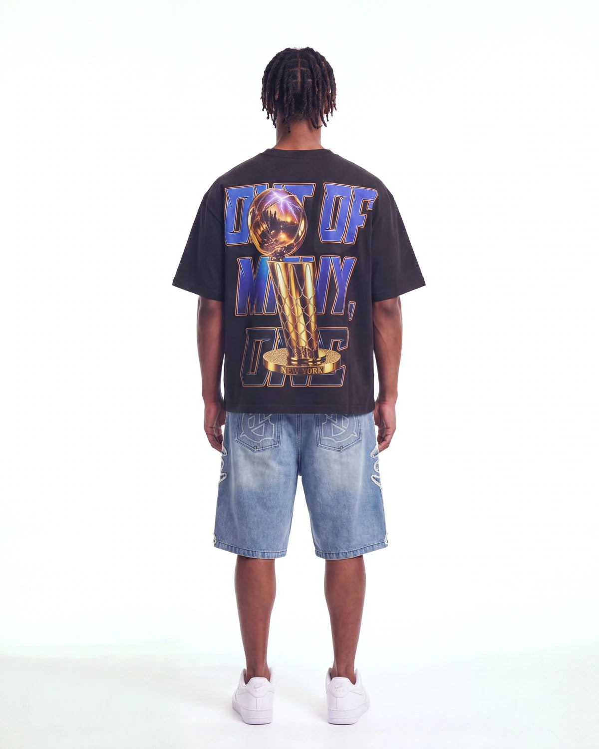 Godspeed Liberty Reigns Tee black, full rear view on model showing the gold trophy and OUT OF MANY, ONE lettering