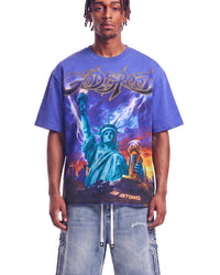Godspeed Liberty Reigns Tee blue, upper body front view on model showing the Statue of Liberty lightning storm graphic
