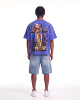 Godspeed Liberty Reigns Tee blue, full rear view on model showing the gold trophy and OUT OF MANY, ONE lettering