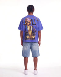 Godspeed Liberty Reigns Tee blue, full rear view on model showing the gold trophy and OUT OF MANY, ONE lettering