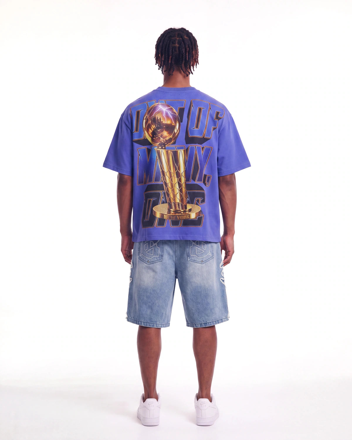 Godspeed Liberty Reigns Tee blue, full rear view on model showing the gold trophy and OUT OF MANY, ONE lettering