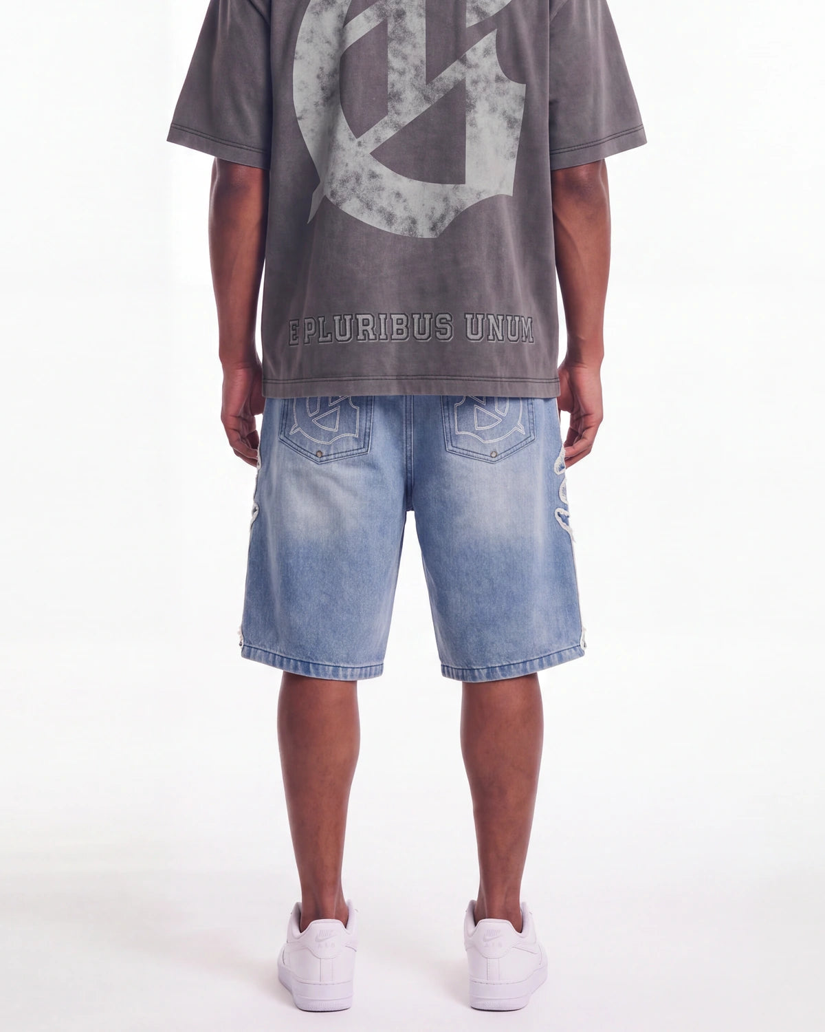 Godspeed Femur Frayed Denim Shorts Blue, worn on-model back view showing the bone appliqué seams