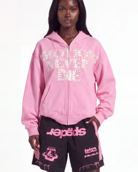 Mixed Emotions End Rhinestone Hoodie pink, upper body front view on model showing the studded EMOTIONS NEVER DIE lettering