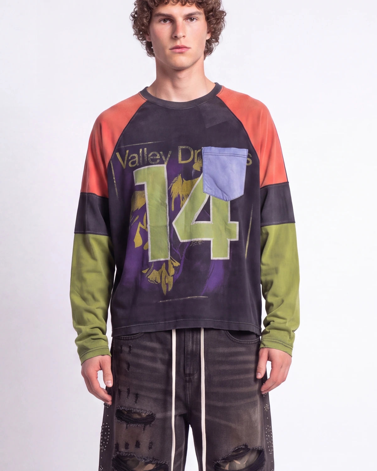 Vale Forever Boomerang L/S Tee black, upper body front view on model showing the appliqué 14 and colorblock sleeves