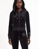 A model wearing a black velvet zip-up hoodie and matching black velvet sweatpants with white embroidered 'RP' logos on the cuffs and thigh, photographed against a plain white studio background.