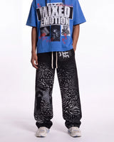 Mixed Emotions Striped Sweatpants black, waist-down front view on model showing the zebra-stripe fade