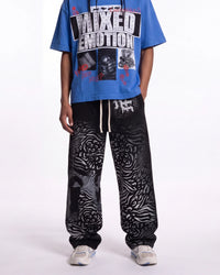 Mixed Emotions Striped Sweatpants black, waist-down front view on model showing the zebra-stripe fade