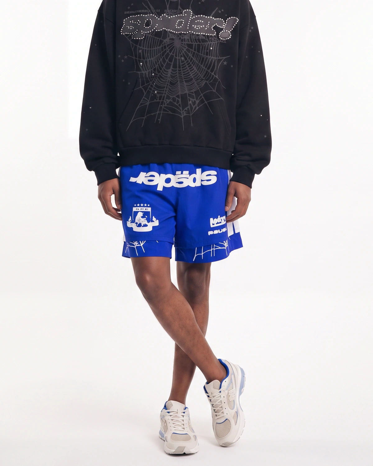 Sp5der Soccer Double Layer Shorts blue, front view on model showing the sp5der wordmark and white side panels