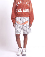 Sp5der Realtree OG Web V2 Sweat Shorts white camo, waist-down front view on model showing the orange sp5der logo