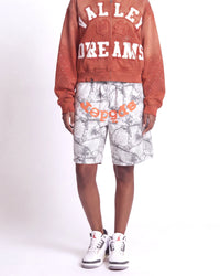 Sp5der Realtree OG Web V2 Sweat Shorts white camo, waist-down front view on model showing the orange sp5der logo