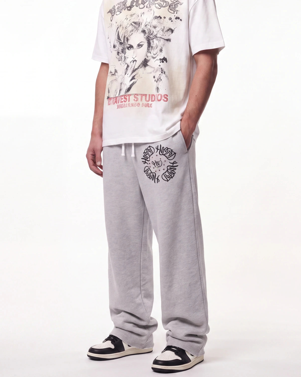 HMDD Chimstone Sweatpants grey, waist-down front view on model showing the circular emblem and HMDD type
