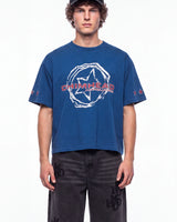 A man wearing a blue short-sleeve t-shirt with a white distressed graphic and red 'CHIMHEAD' text on the chest, paired with dark gray jeans, photographed against a plain white background.