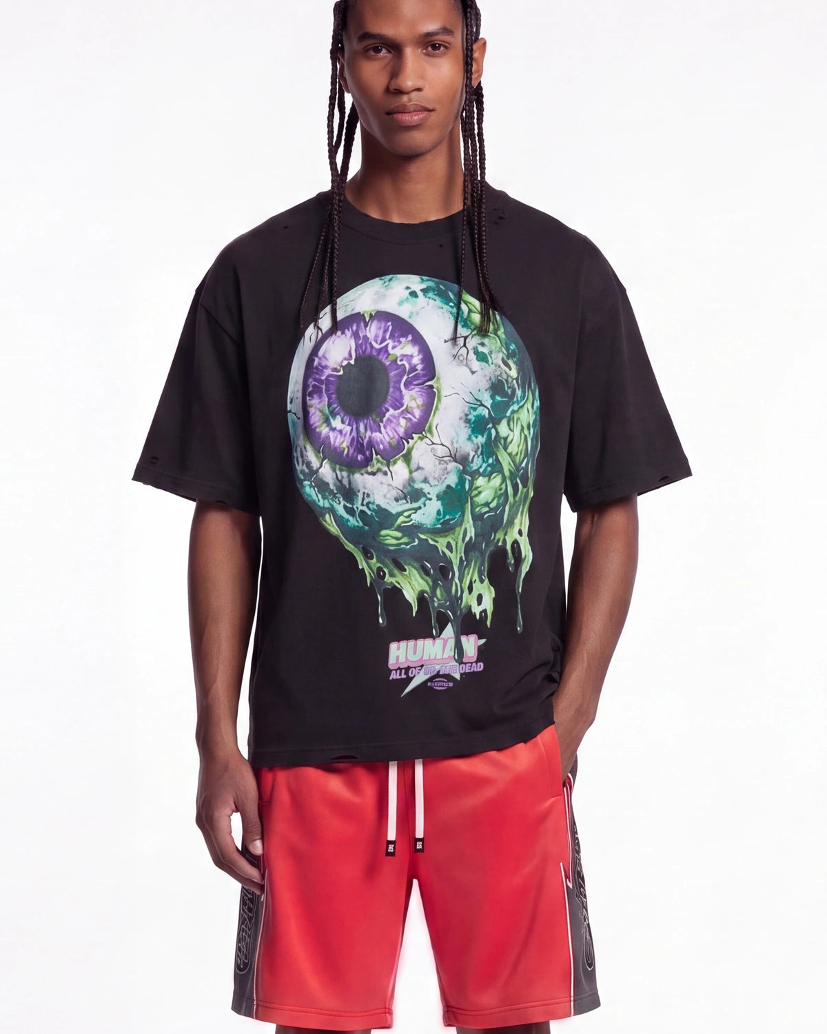 All Human Hereditary Tee black, upper body front view on model showing the dripping green and purple eyeball graphic
