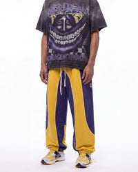 Vale Forever Sport 2000 Sweats Oregon navy and gold, waist-down front view on model showing the colorblock panels and leg print