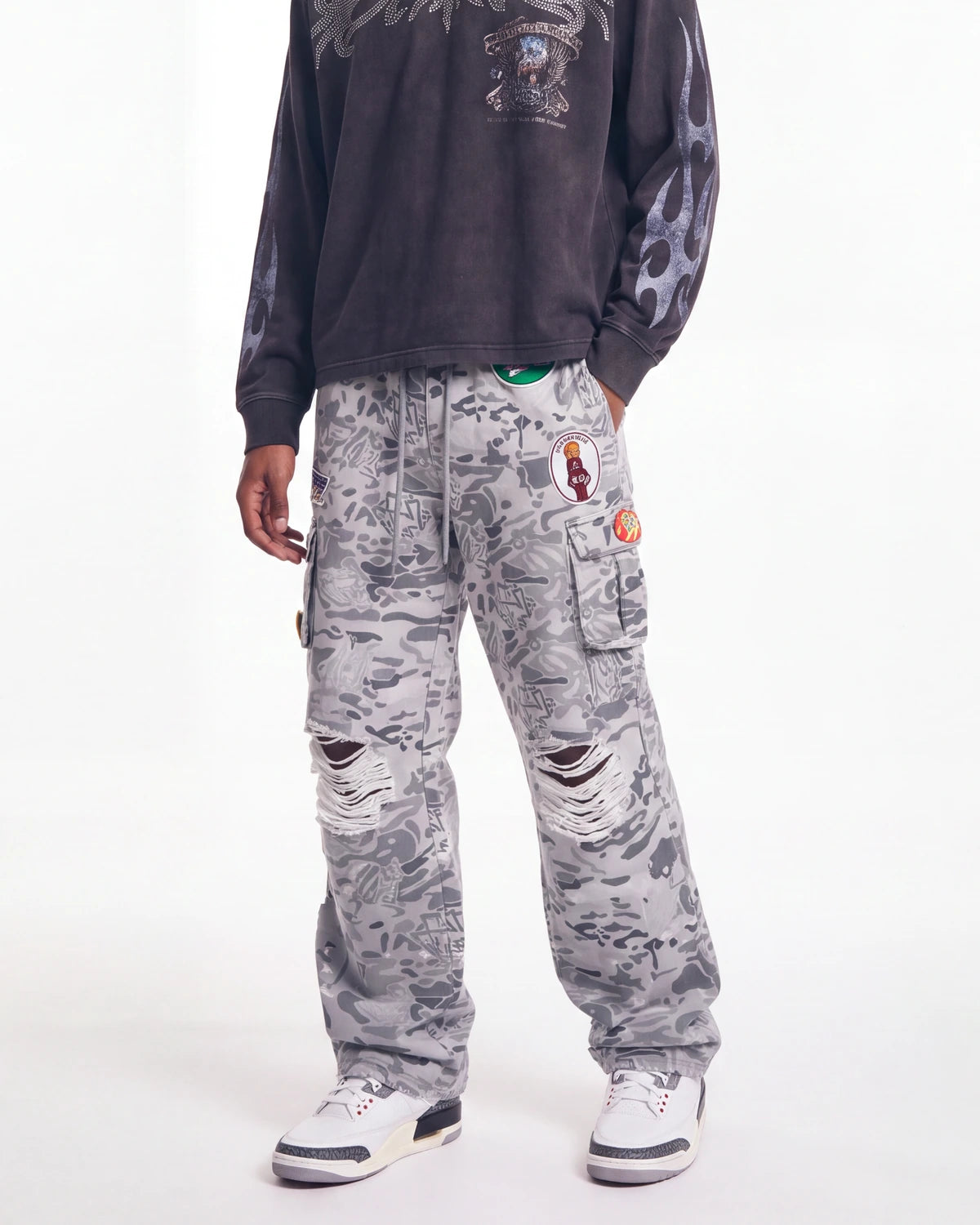 Triple Sevens Camo Sweatpants grey, waist-down front view on model showing the camo print and patches