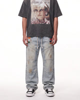 Triple Sevens Moto Denim Pants blue, waist-down front view on model showing the light-wash denim and patches